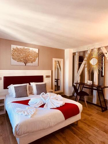 a bedroom with a large bed and a desk at Pavillon Opéra Lafayette in Paris