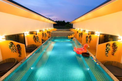 a swimming pool with a red rubber duck in the middle of a building at Fresh Resort Pattaya in Ban Huai Yai