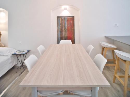 a table in a room with chairs and a bed at Hotel Medusa in Finale Ligure