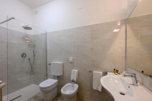 a bathroom with a sink and a toilet and a shower at Albergo Reggio in Reggio Emilia