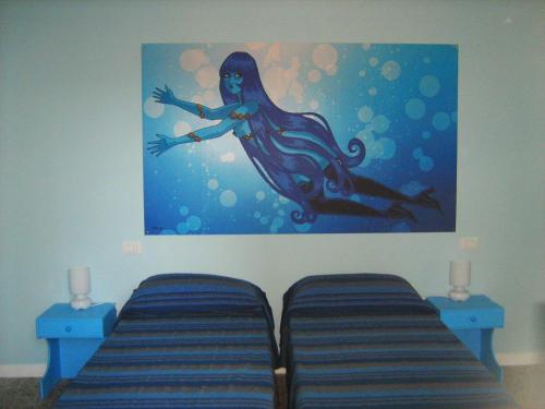 una pintura de una sirena colgada en una pared en Sirenapop Concept B&b, en Rímini