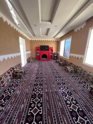a large room with a rug on the floor at شاليهات توليب in Sabt Alalayah