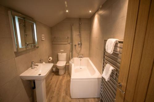 a bathroom with a sink and a tub and a toilet at Henry in Richmond