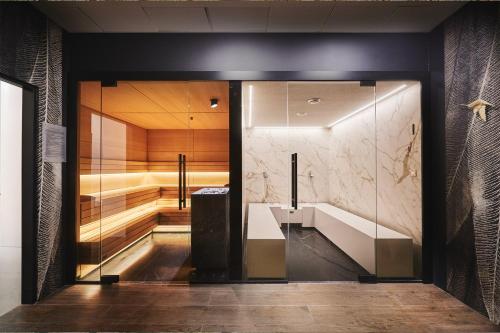 a bathroom with a sink and a shower at Hotel Narvil Conference & Spa in Serock