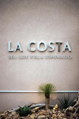 a sign for the la costa sea side villaustinianota at LACOSTA in Hōden