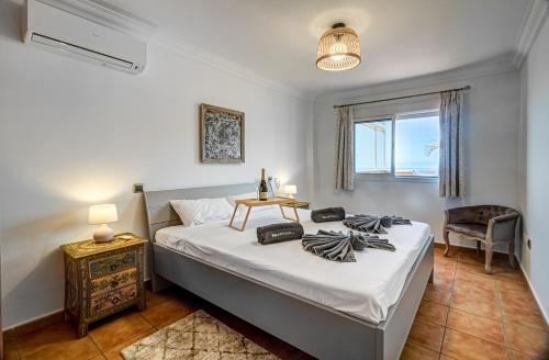 a bedroom with a bed with a table and a chair at Nayara Sunset in Adeje