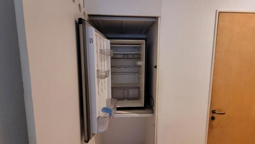an empty refrigerator with its door open in a room at Shangri La in Rosario