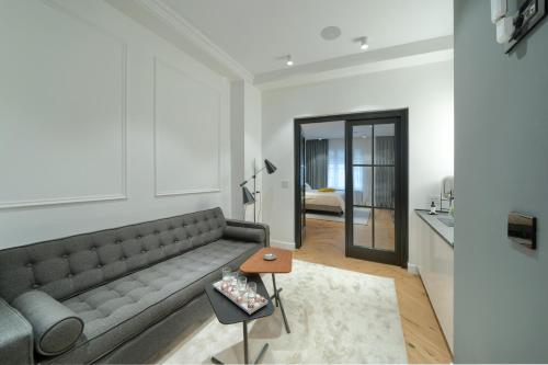 a living room with a couch and a table at Elysium Residence in Timişoara