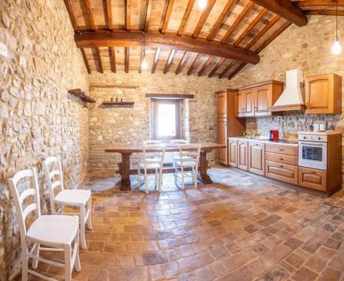 a kitchen with a table and chairs in a room at Abbazia San Pietro in Valle in Vagli