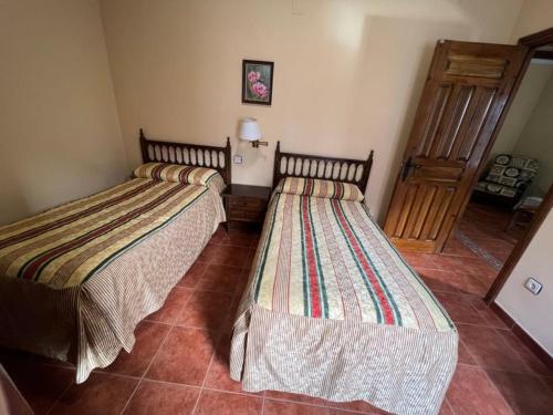 A bed or beds in a room at Apartamentos Turísticos La Posada