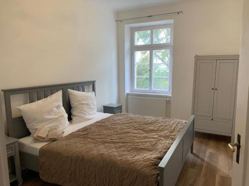 a bedroom with a bed and a window at Apartment on the ground floor in Gutenzell-Hürbel