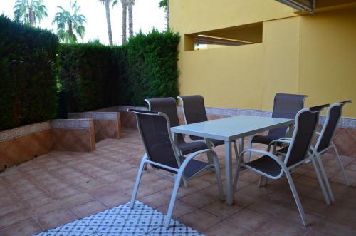 a table and chairs sitting on a patio at Las Arenas-Islantilla-Huelva in Islantilla