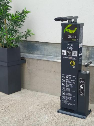 a sign sitting on the ground next to a plant at Zuia Suites in Murguía