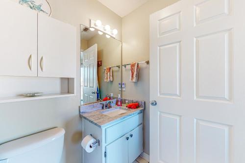 a bathroom with a blue sink and a white door at Sunset Harbor Villas #4-421 in Navarre