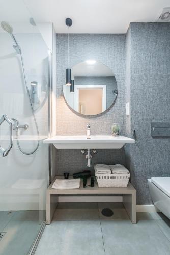 a bathroom with a sink and a mirror at Smartr Las Palmas in Las Palmas de Gran Canaria