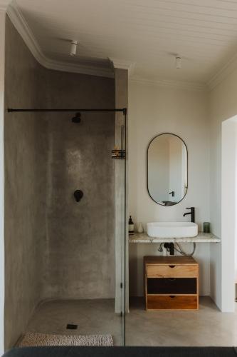 a bathroom with a sink and a mirror at Spionkop Eco Cabin in Reddersburg