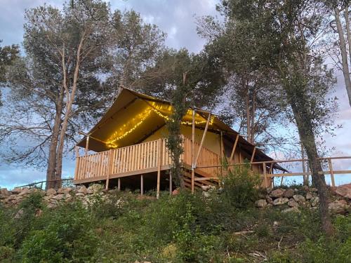 a house in the woods with a roof at Hostal la Salut de Terrades in Terrades