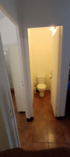 a white bathroom with a toilet in a hallway at Les Gîtes de Fond Bellemare in Case-Pilote