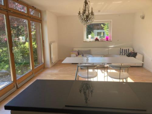 a living room with a table and chairs at Tu Casa Chiemsee in Gstadt am Chiemsee