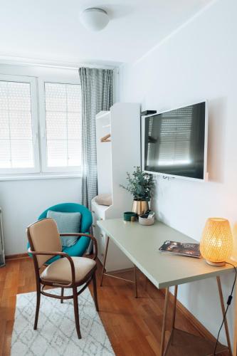 a desk and a chair in a room at Zeus Nest Apartment in Belgrade
