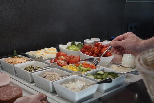 a table with a bunch of bowls of food at Mahorko Wein Wellness Wasserbüffel in Glanz an der Weinstraße 