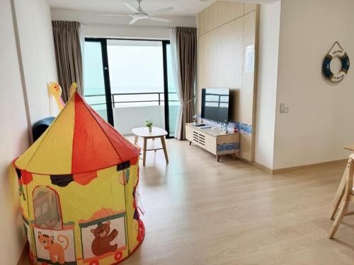 a childs room with a play tent on the floor at Mutiara Melaka Beach Resort by Minso in Tangga Batu
