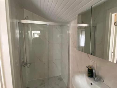 a bathroom with a shower and a sink at Gökdere Evleri in Antalya