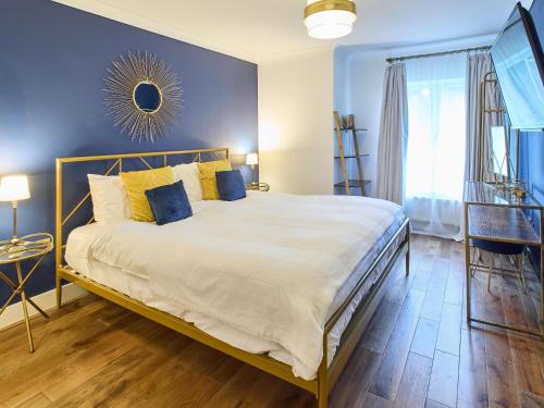a bedroom with a large bed with yellow pillows at Host & Stay - Bellflower Mews in Canterbury