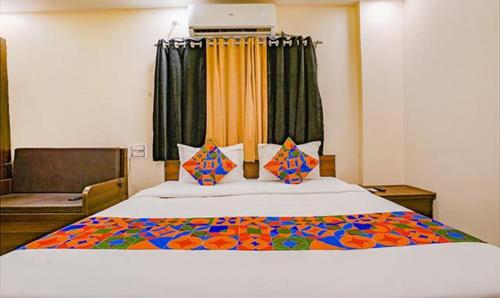 a bedroom with a large bed in a room at FabHotel Royal Inn NS in Pune