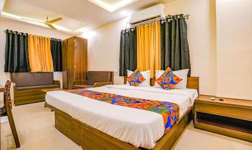 a bedroom with a large bed in a room at FabHotel Royal Inn NS in Pune