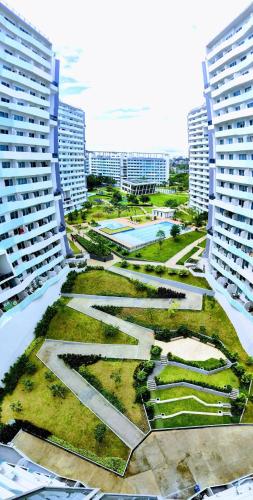 an aerial view of a park between two buildings at Cozy Oasis, Mountain + Skyline View, Free Pool in Manila