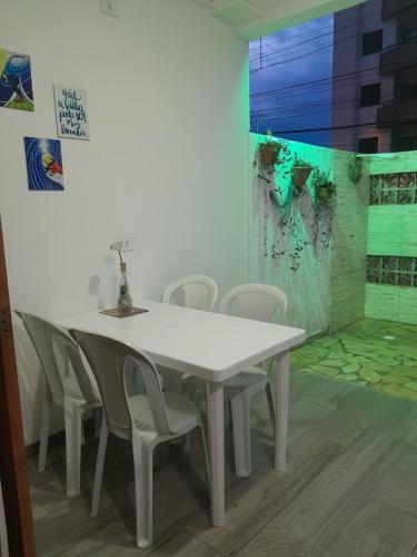 a white table and chairs in a room at Chalés Manacá da Serra in Ubatuba