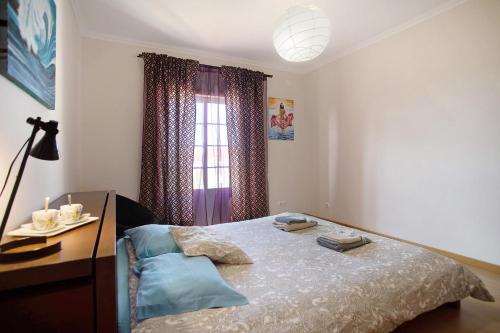 a bedroom with a bed and a desk and a window at A O - Ferrel House Casual in Ferrel