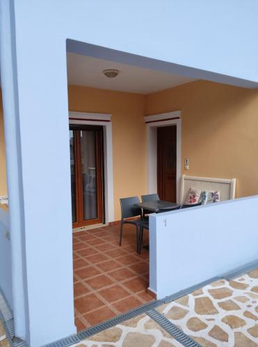 a view of a living room with a table and chairs at Anemi Leros Apartments 3 in Panteli
