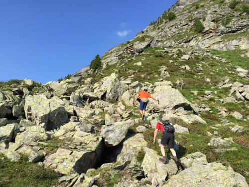 two people walking on rocks on a mountain at Wellnessappartements Margit in Alpbach