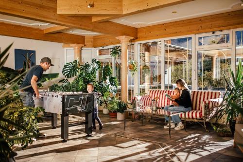 a man playing a ping pong table in a garden at Appartement Hotel Garni Alpenstüble in Mittelberg