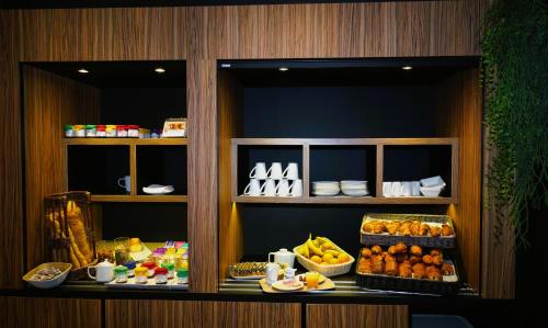 a display case in a restaurant with food on it at Kyriad Clermont Ferrand Nord - Riom in Riom