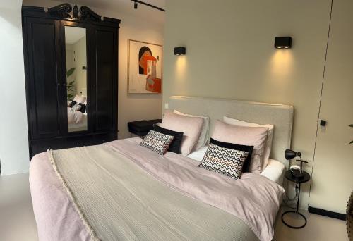 a bedroom with a large bed with pillows at B&B Urban Oasis in Amsterdam