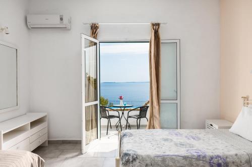 a bedroom with a bed and a view of the ocean at Four-Bedroom Villa Eleni by Konnect, with Private Pool & Stunning Seaview in Barbati
