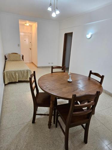 Habitación con mesa, 2 sillas y 1 cama en Departamento en Plaza mitre! en Mar del Plata
