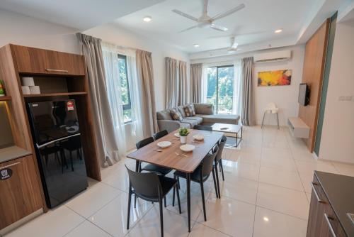 a kitchen and living room with a table and chairs at Ipoh Tambun Sunway Onsen Suite 3R2B Maya in Tambun