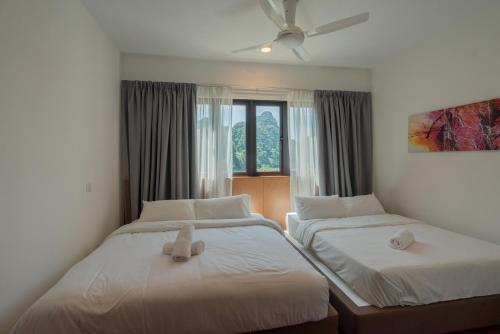 a bedroom with two beds with stuffed animals on them at Ipoh Tambun Sunway Onsen Suite 3R2B Maya in Tambun