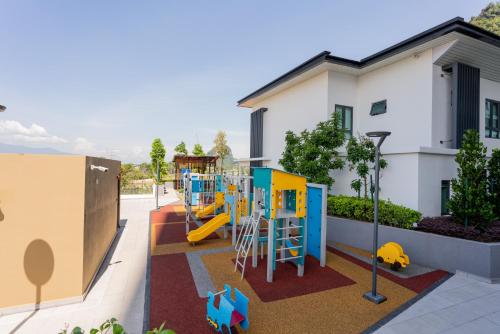 a playground with a slide in front of a building at Ipoh Tambun Sunway Onsen Suite 3R2B Maya in Tambun