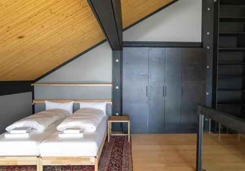 two beds in a room with a roof at Lauchernalp Resort Residences in Wiler