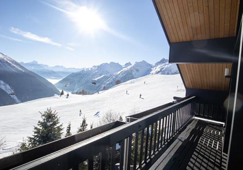 a balcony with a view of a ski slope at Lauchernalp Resort Residences in Wiler