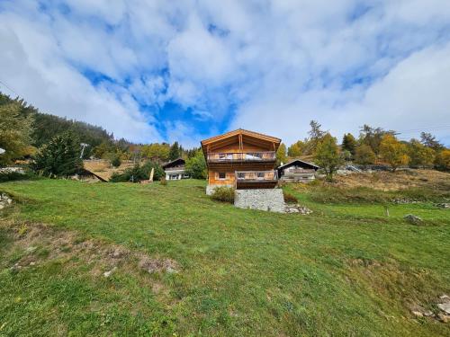 a house on a hill with a green field at Müelera in Blatten bei Naters
