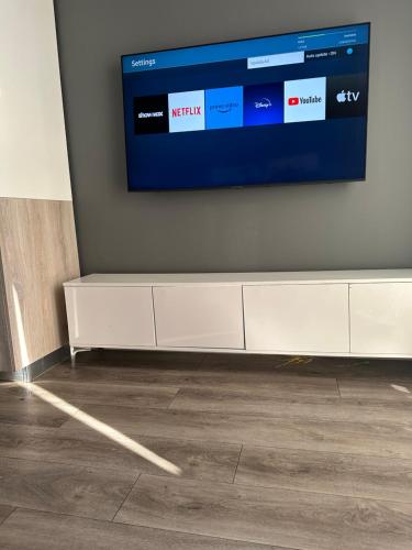 a flat screen tv hanging on a wall at The Capital Trilogy Menlyn Maine Apartments 913 in Pretoria