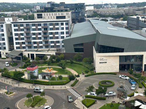 an aerial view of a large building with a parking lot at The Capital Trilogy Menlyn Maine Apartments 913 in Pretoria