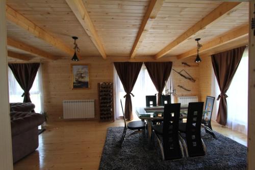 a living room with a dining room table and chairs at Holiday house - Berane in Berane
