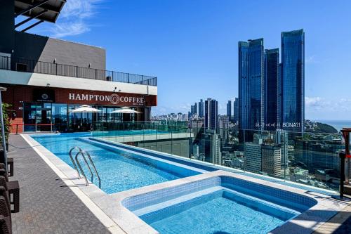 a swimming pool on the roof of a building at Haeundae Bona Travel in Busan